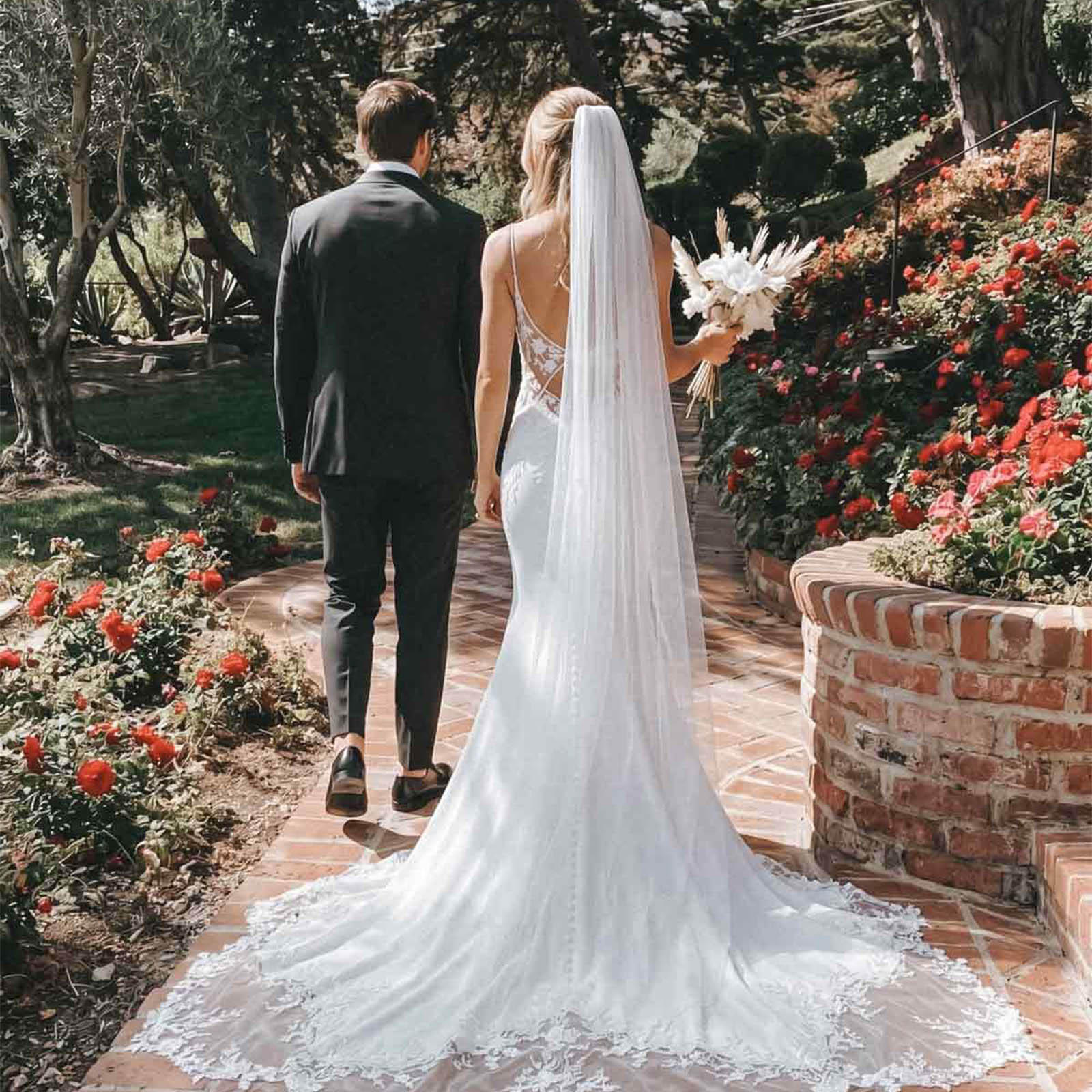 I cannot get over how stunning the back of this gown is! The lace detailing on the sheer back and that breathtaking chapel train made me feel like absolute royalty walking down the aisle. It flows so beautifully and the floral appliques are just perfection. Highly recommend!😍😍